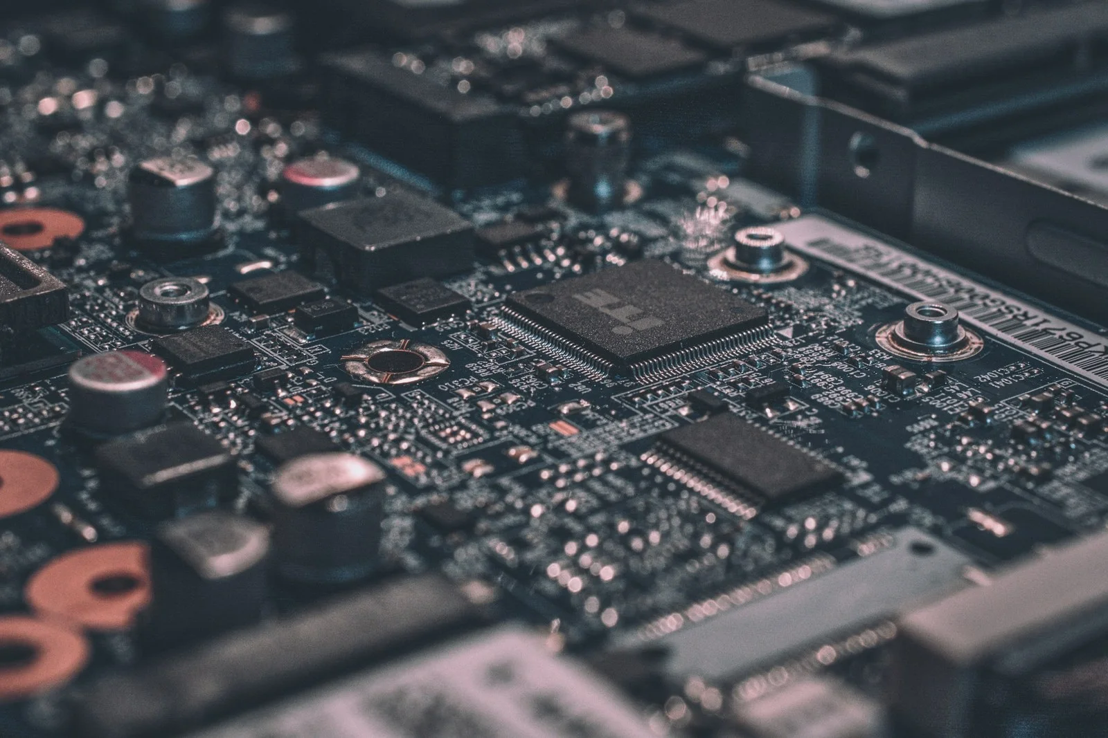 Macro view of a high-density multi-layer circuit board with processors, capacitors, and fine-pitch traces